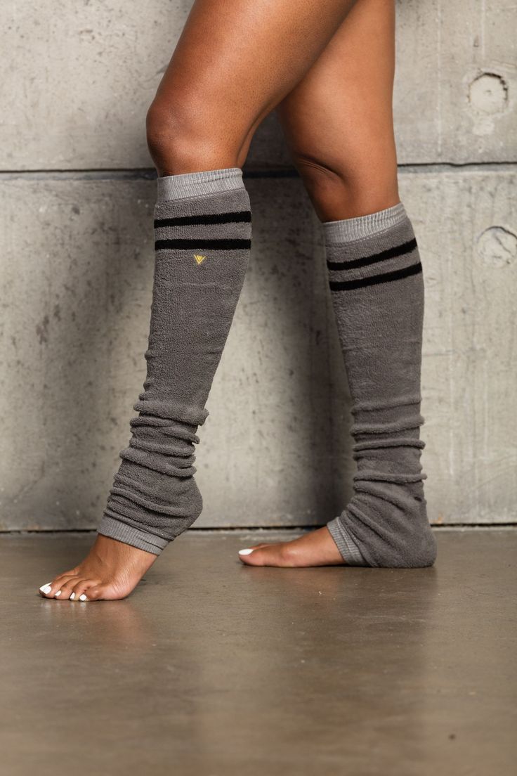 CLASSIC TERRY LEGWARMERS Collection Soft terry fabric Gold embroidered logo on the side of the legwarmer Wear three ways: thigh high, below the knee, or scrunched down Fabric Details: 80% cotton 20% spandex Wash and Care: Hand wash, no bleach, line dry. Cotton Knee-high Leg Warmers For Fall, Footless Leg Warmers For Yoga In Winter, Stretch Leg Warmers For Yoga In Winter, Fitted Cotton Knee-high Legwear, Black Cotton Knee-high Leg Warmers, Trendy Black Cotton Leg Warmers, Casual Winter Leg Warmers For Yoga, Casual Leg Warmers For Yoga In Winter, Casual Winter Yoga Leg Warmers