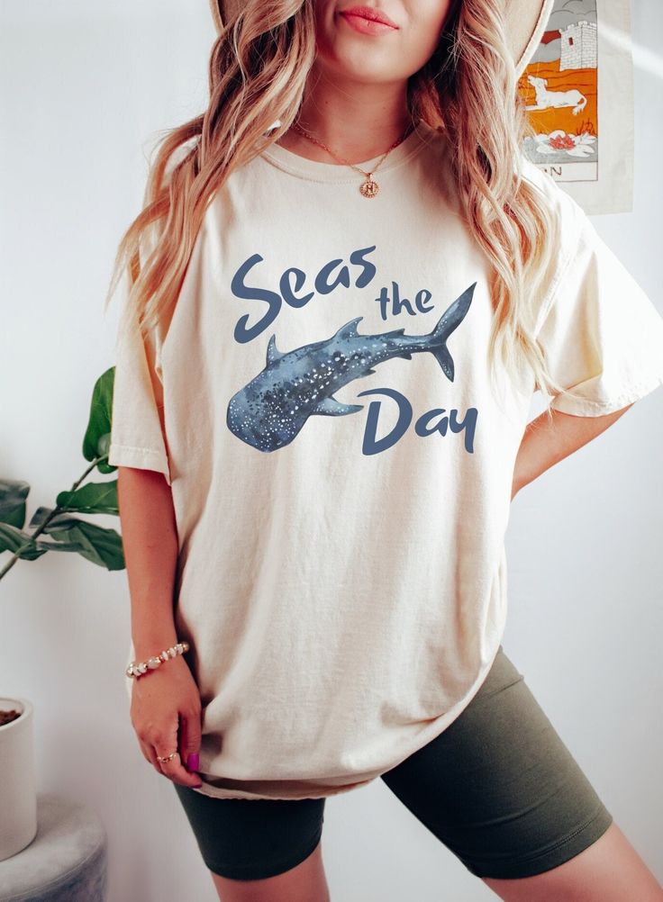 This Comfort Colors whale shark shirt is perfect for your everyday style or your next beach day. The soft-washed, garment-dyed fabric brings extra coziness to your wardrobe, while the relaxed fit makes it an excellent daily choice! 🤩 Tip: THESE RUN TRUE TO SIZE. If you want an oversized look, size up 2-3 sizes. 😉 ✅ Shirt Information: Comfort Colors Unisex Shirt - 100% ring-spun cotton - Medium fabric  - Relaxed fit ✅Design Printing Design printed using Direct to Garment (DTG) print technology. Casual Short Sleeve Shark Design Tops, Casual Short Sleeve T-shirt With Shark Design, Casual Short Sleeve Top With Shark Design, Casual Cotton T-shirt With Shark Design, Cotton T-shirt With Shark Design For Summer, Casual Summer T-shirt With Shark Design, Summer Short Sleeve T-shirt With Shark Design, Summer Short Sleeve Tops With Shark Design, Casual White Shark Design Tops