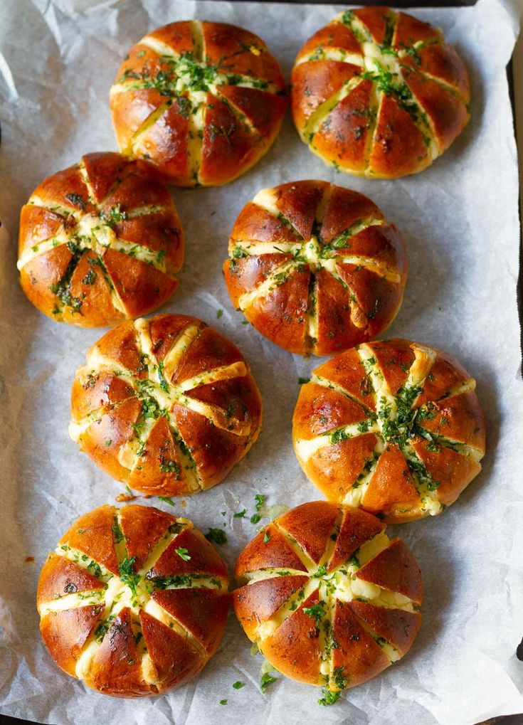 several small rolls with cheese and herbs on them