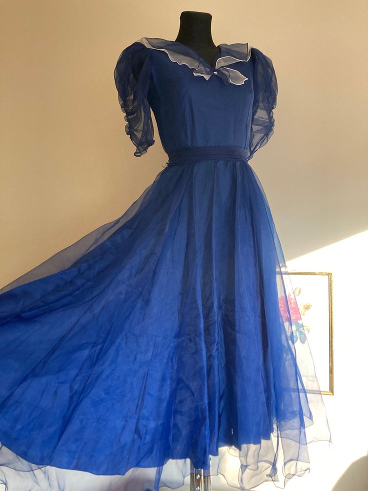 ♥ Vintage stunning princess ball gown/ evening dress/ costume. ♥ Very full big skirt with sheer overlay. ♥ Cute double layer nautical collar with a little bow.  ♥ Matching ribbon tie. The back hemline is slightly longer for dramatic look. ♥ Big puffy sheer half sleeves. ♥ Polyester fabric. ♥ The dress closes with a zipper on the back. ♥ Good vintage condition. The dress has been gently hand-washed and only needs some steaming (the photos have been taken without ironing after washing, therefore t Vintage Ball Gown, Big Skirt, Vintage Ball Gowns, Big Skirts, Princess Ball Gowns, Ribbon Belt, Ball Gowns Evening, Sheer Overlay, Dramatic Look