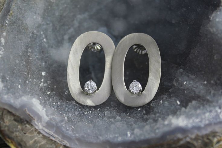 These earrings are handmade from recycled 14k white gold. Each earring contains one .15ct G color SI1 clarity diamond. Together, these earrings weigh 4.4 grams. The posts are 14k white gold and come with 14k white gold friction backs. Each earring measures 22.5mm (14.5/16 inch) in long and 9.8mm (9.5/16 inch) wide. These earrings are a modern and classy design that can be dressed up or down for any occasion. Available in brushed or high polish, please indicate at checkout. Oval Fine Jewelry Diamond Earrings With Single Cut Diamonds, Oval Single Cut Diamond Earrings, Diamond White Oval Earrings With Single Cut Diamonds, Oval Diamond White Earrings With Single Cut Diamonds, Oval White Gold Earrings With Single Cut Diamonds, Modern Round Diamond Earrings As Gift, Modern Brilliant Cut Earrings For Gift, Modern Oval Brilliant Cut Diamond Earrings, Sterling Silver Single Diamond Earrings For Anniversary