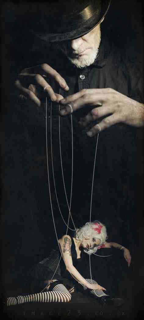 an old man is trying to fix a doll's strings with the caption, what is pain?