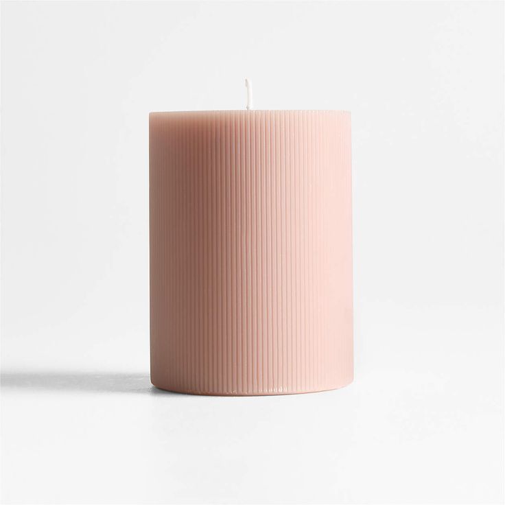 a pink candle sitting on top of a white table