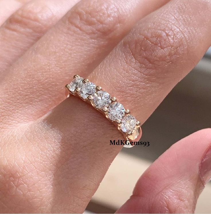 a woman's hand with a diamond ring on it