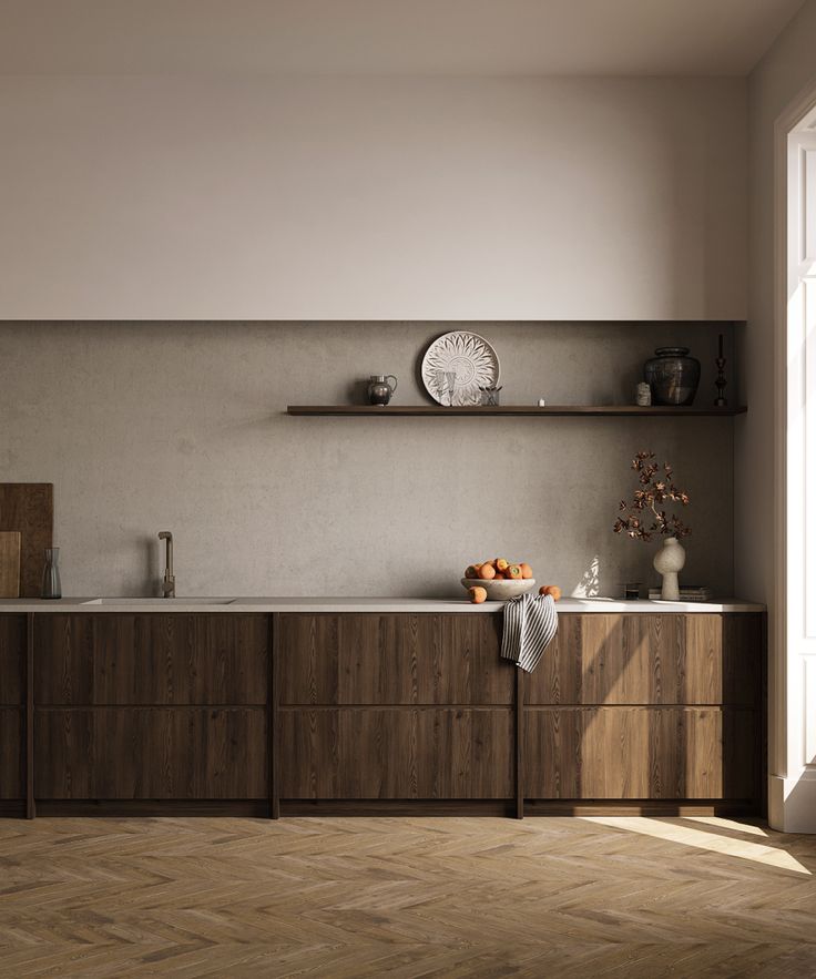 an empty kitchen with wooden cabinets and white counter tops, along with a clock on the wall