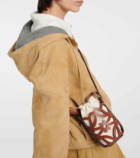 Material: leather.Lining: fabric.Made in Portugal.Designer color name: Tan/Ecru.Closure: drawstring top.Shoulder strap.Height 20cm-8'.Width 10cm-4'.Depth 8cm-3'.Length shoulder strap 110cm-43.5' Spring Leather Bags With Leather Trim, Spring Leather Shoulder Bag With Leather Trim, Designer Beige Bags For Fall, Beige Leather Bucket Bag For Fall, Cream Leather Bag For Fall, Fall Beige Leather Bucket Bag, Designer Beige Shoulder Bag For Spring, Leather Bucket Bag In Beige For Spring, Spring Leather Beige Bucket Bag