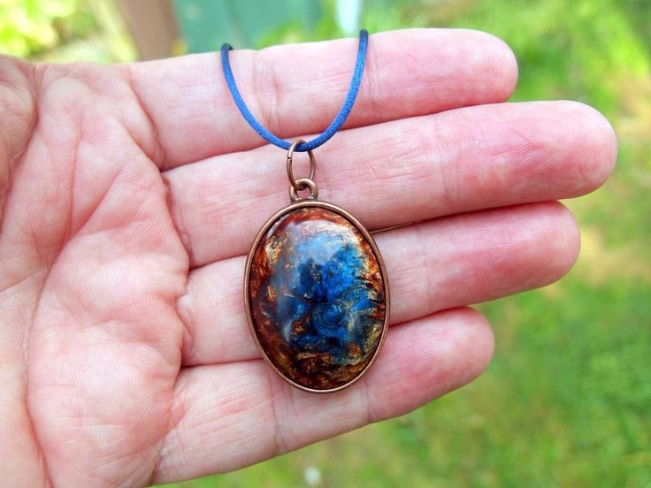 This one-of-a-kind handcrafted necklace features a fun, vibrant pendant crafted from hand-mixed resins and carved to a lovely form and set into an antiqued copper bezel. I polish these to a buttery smooth final finish so that if feels wonderful to the touch. Blue satin necklace with sliding knots that allow the necklace to adjusted to any length up to approximately 37".  This style of necklace is very eye-catching! Only purchase if you can withstand relentless compliments! :-) I'll be making a l Hand Painted Blue Spiritual Necklace, One-of-a-kind Artsy Pendant Jewelry, One Of A Kind Artsy Pendant Jewelry, Artsy One-of-a-kind Pendant Jewelry, Unique Hand-painted Copper Jewelry, Hand Painted Spiritual Resin Jewelry, Hand Painted Amulet Necklace With Round Pendant, Unique Hand Painted Copper Jewelry, Artsy Blue Round Pendant Jewelry