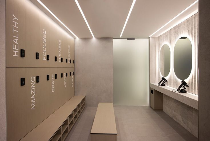 an empty locker room with several sinks and mirrors on the wall next to each other