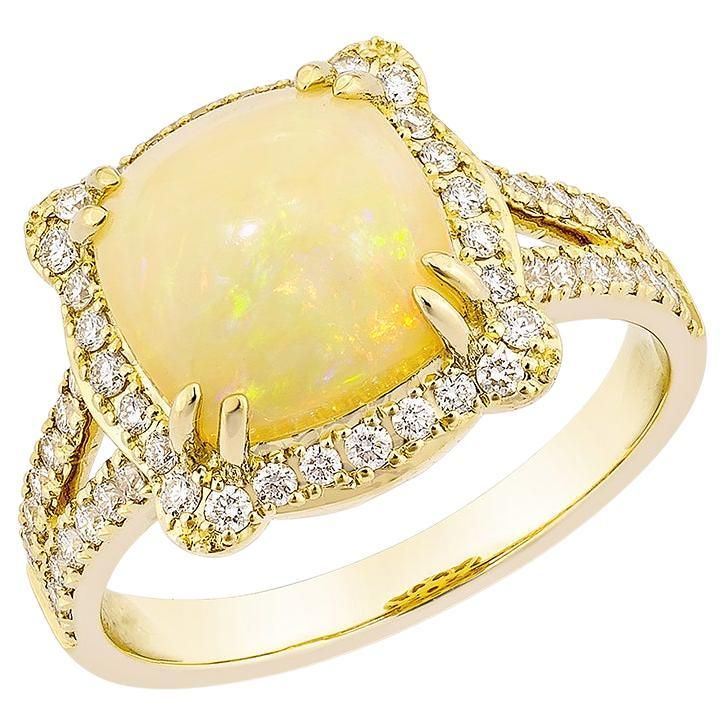 an opal and diamond ring set in yellow gold with white diamonds on the sides