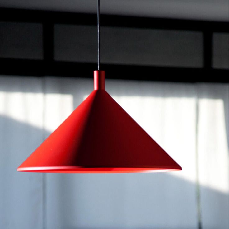 a red light hanging from a ceiling in a room