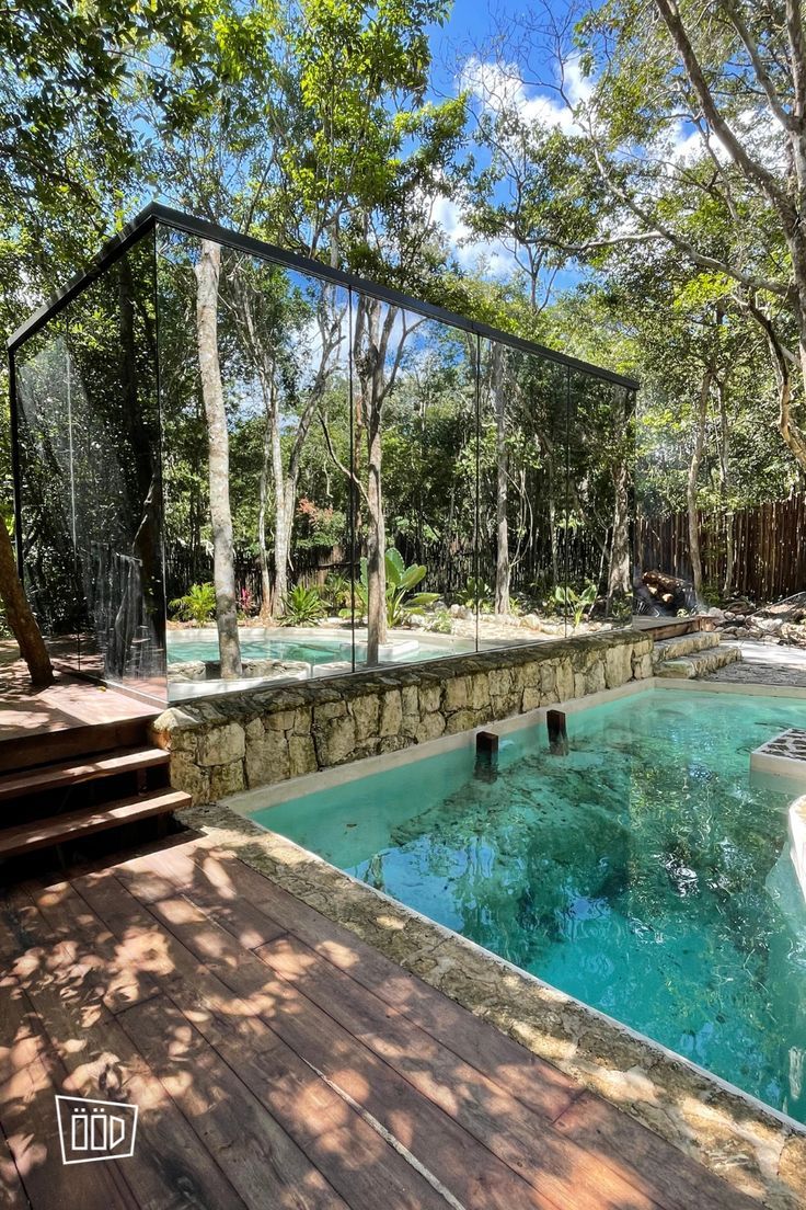 an outdoor swimming pool surrounded by trees and steps leading up to the water's edge