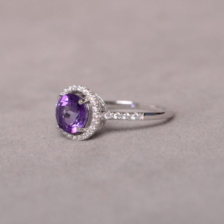 This is a 7mm natural amethyst birthstone ring set in solid sterling silver and with rhodium plated. The ring features a clear round faceted natural amethyst and lots of tiny zircon around of the main stone. If you want other size, please contact me to order and it will take 7-10 days to finish. The item is sent in a beautiful gift box You can realize more lovely stuff clicking the link https://www.etsy.com/shop/knightjewelry?refshopsection_shophome_leftnav Elegant Amethyst Cubic Zirconia Birthstone Ring, Elegant White Gold Amethyst Birthstone Ring, Elegant Amethyst Birthstone Ring In Cubic Zirconia, Classic Amethyst Birthstone Promise Ring, Classic Amethyst Birthstone Ring In White Gold, Timeless Amethyst Promise Ring, Elegant Amethyst Crystal Ring Round Cut, Classic Round Gemstones With Center Stone, Classic Amethyst Crystal Ring For Anniversary