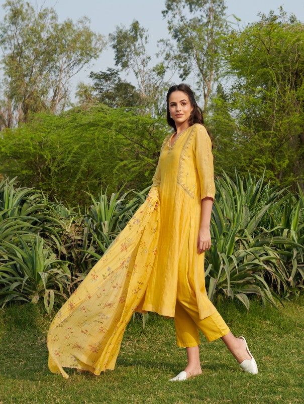 Kurta with pretty Thread embroidery, floral dupatta & Embroidered pants Fabric: Handwoven Mal Cotton Silk Color: Yellow Embroidery Details: Thread embroidery Note: Wash Care - Dry clean only The product will be shipped within 20-25 days of order placed Measurement: Kurta / Dress / Top Standard Body Measurement ( in Inch) Size Bust Waist Hip Shoulder Armhole Sleeve Length XS 34 32 36 14 16.5 16 46 S 36 34 38 14 17 16 46 M 38 36 40 15 17.5 16 46 L 40 38 42 15.5 18.5 16 46 XL 42 40 44 16 19.5 16 46 Semi-stitched Slub Silk Salwar Kameez With Floral Embroidery, Spring Chanderi Palazzo Set With Straight Kurta, Spring Embroidered Palazzo Set In Mulmul, Spring Anarkali Set With Straight Kurta And Dupatta, Summer Embroidered Palazzo Set In Mulmul, Spring Embroidered Mulmul Palazzo Set, Summer Embroidered Mulmul Palazzo Set, Spring Chanderi Salwar Kameez With Embroidered Border, Summer Chanderi Kurta With Sheer Dupatta