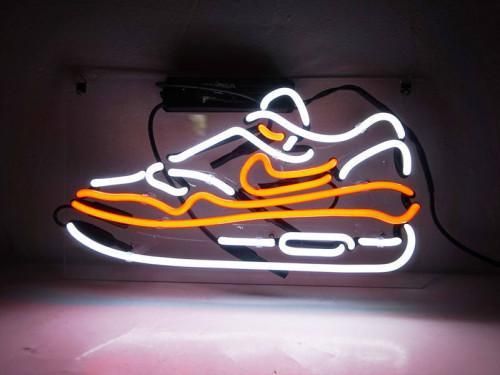 a neon sign that has a shoe on it