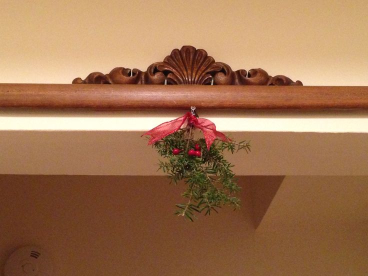 a red bow hanging from the top of a mantle