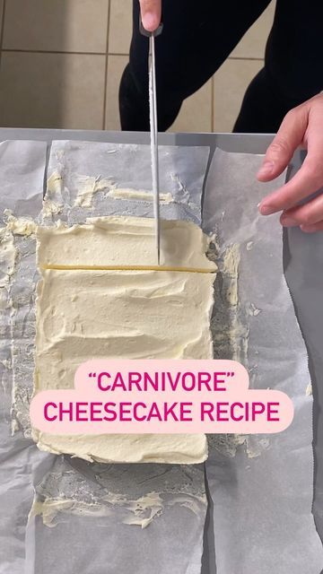 a person cutting into a cake with a knife on top of it and the words carnivore cheesecake recipe written in pink