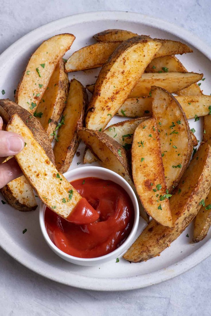 a white plate topped with french fries and ketchup