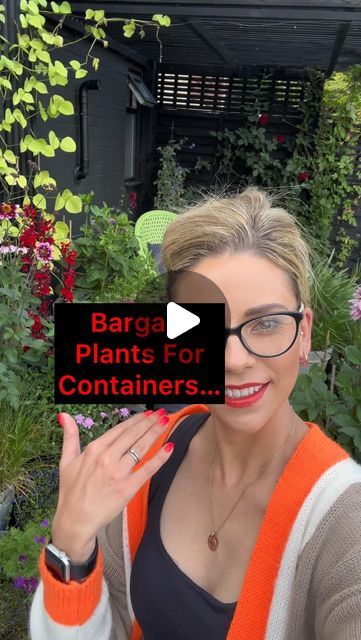 a woman holding up a sign that says barga plants for containers in front of her face