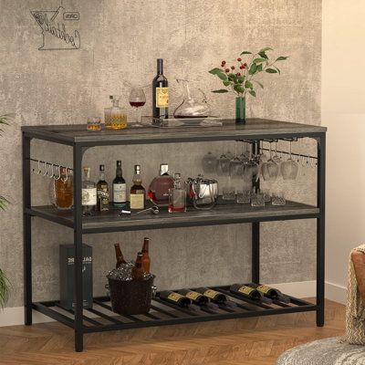 a bar cart with bottles and glasses on it