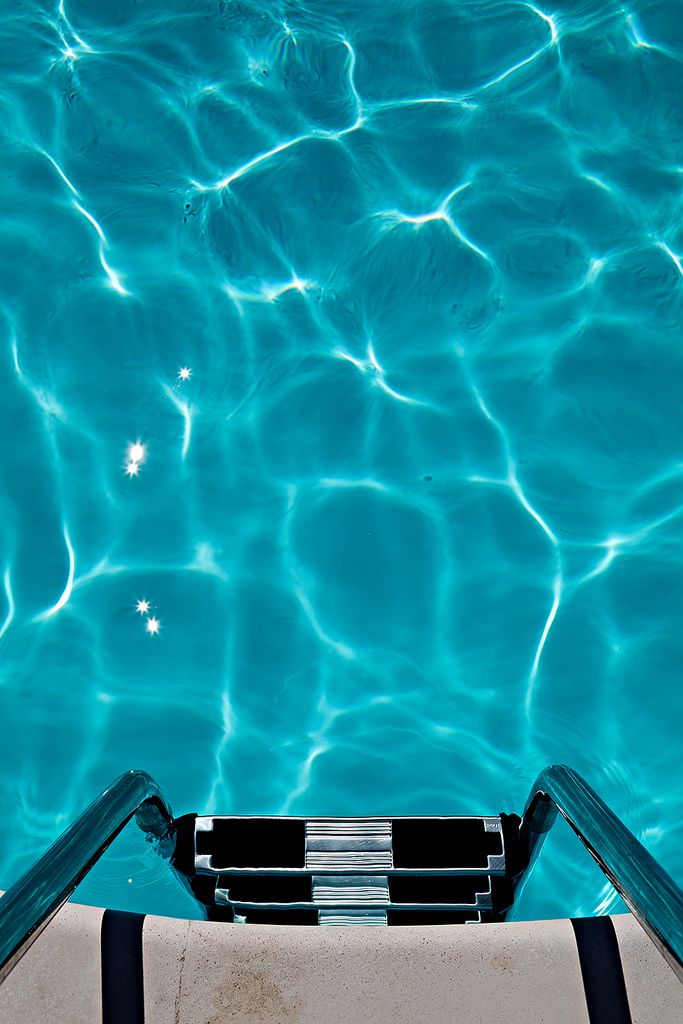 an empty pool with clear blue water