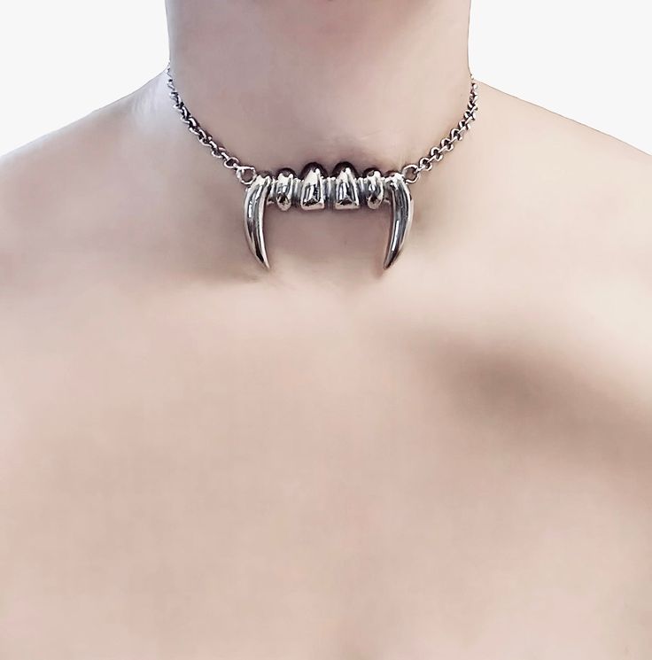 Vampire Bite Choker 🖤 This choker is the perfect way to add a touch of darkness to your look. The rhodium plated chain is durable and tarnish-resistant, while the large silver vampire teeth charm is a statement piece that will turn heads. 🖤 Only one available as I like to make one of a kind pieces so that you have a unique, standout, rare, special piece that you can't find anywhere else. Keep your jewellery away from water, oils, perfumes and make sure to remove before showering and sleeping i Sterling Silver Punk Style Chain Jewelry, Halloween Silver Claw Jewelry, Gothic Silver Chain Choker Jewelry, Gothic Silver Clavicle Chain Necklace, Gothic Silver Choker Necklace, Silver Vampire Style Metal Jewelry, Silver Vampire Style Necklace, Alternative Style Jewelry Choker With Adjustable Chain, Alternative Halloween Choker Jewelry