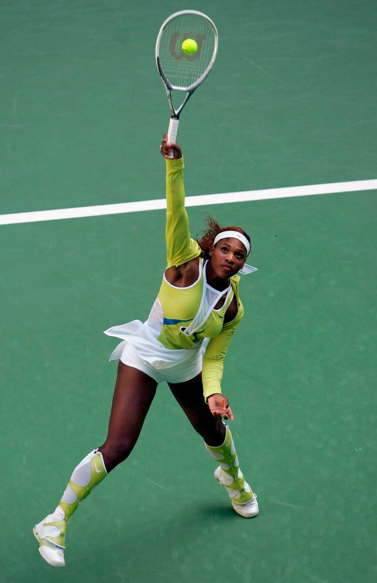 a female tennis player is swinging her racket to hit the ball on the court