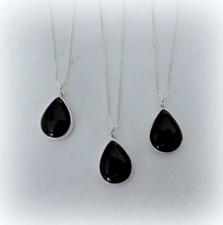 "These are gorgeous genuine black onyx pendants, each stone has been bezel set into solid .925 sterling silver and hangs from a sterling silver chain in the length of your choice. The onyx is a true black and is excellent quality. Item description: Stone: Black Onyx Metal: Sterling Silver .925 Finsh: Smooth Shape: Teardrop Size: 1 1/8\" by 5/8\" (approximate) Chain: Cable, Box, Satellite, Medium Cable or Open Link Length: 16\" to 30\" (choose from drop down menu) Clasp: Lobster Claw, Box-spring Black Teardrop Gemstone Jewelry, Black Teardrop Gemstone Necklace, Teardrop Onyx Gemstone Jewelry, Black Teardrop Pendant Necklace With Gemstone, Black Teardrop Necklace With Natural Stones, Black Teardrop Natural Stone Jewelry, Black Drop Jewelry, Formal Black Necklaces With Natural Stones, Silver Teardrop Jewelry With Black Enamel