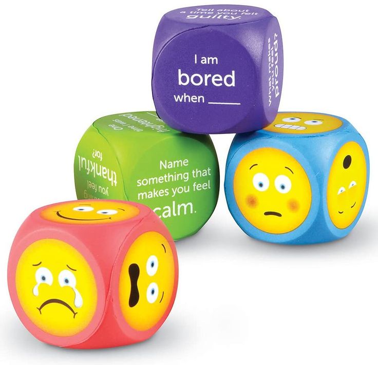 three different colored dices with faces and words written on them, one saying i am bored