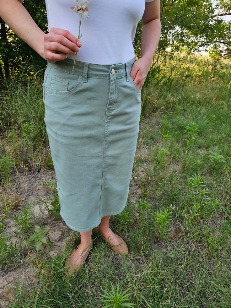 Elevate your wardrobe with our Sage Denim Skirt! In a beautiful, versatile sage color, this basic pencil skirt features a finished hem and convenient pockets. With a button and zipper closure, it's a must-have for any fashion-forward individual. Update your style with this stylish and functional piece today! 27" length model is 5'4" bust 36" waist 29" hips 40" wearing size small Light Wash Skirt With Pockets For Fall, High Waist Pencil Skirt With Pockets For Spring, Spring High Waist Solid Cargo Skirt, Fitted Cargo Pencil Skirt For Spring, Spring Cargo Pencil Skirt With Pockets, Spring Mid-rise Cargo Skirt, Spring Fitted Mid-rise Cargo Skirt, Spring Cotton Pencil Skirt With Pockets, Casual High Rise Pencil Skirt For Spring