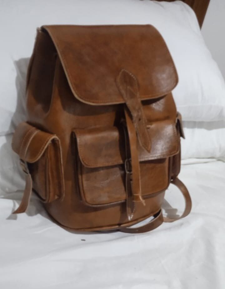 Moroccan leather backpack, good quality, handmade Genuine leather.perfect for work or school or travel. Our leather bags are handmade by highly skilled artisans in a small leather workshop in the old medina. This 100% organic backpack is unique, plain, simple and soft, designed to highlight the natural beauty of leather. The bag has 5 pockets can be carried casually on the hand, shoulder or carried as a backpack. It can be used at school, while traveling or in any other activity. Finely handcraf Luxury Rectangular Leather Backpack For Trips, Luxury Leather Rectangular Backpack For Trips, Luxury Leather Backpack For Trips, Vintage Leather Backpack-style Shoulder Bag, Large Capacity Leather Satchel For Trips, Large Capacity Leather Shoulder Bag For Trips, Vintage Leather Standard Backpack, Leather-backed Backpack Shoulder Bag For Trips, Leather Backed Shoulder Bag Backpack For Trips