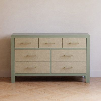 a green dresser sitting in front of a white wall