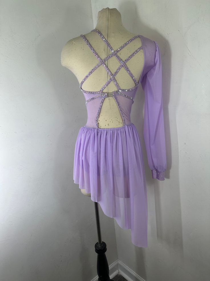 a purple leotard dress is displayed on a mannequin