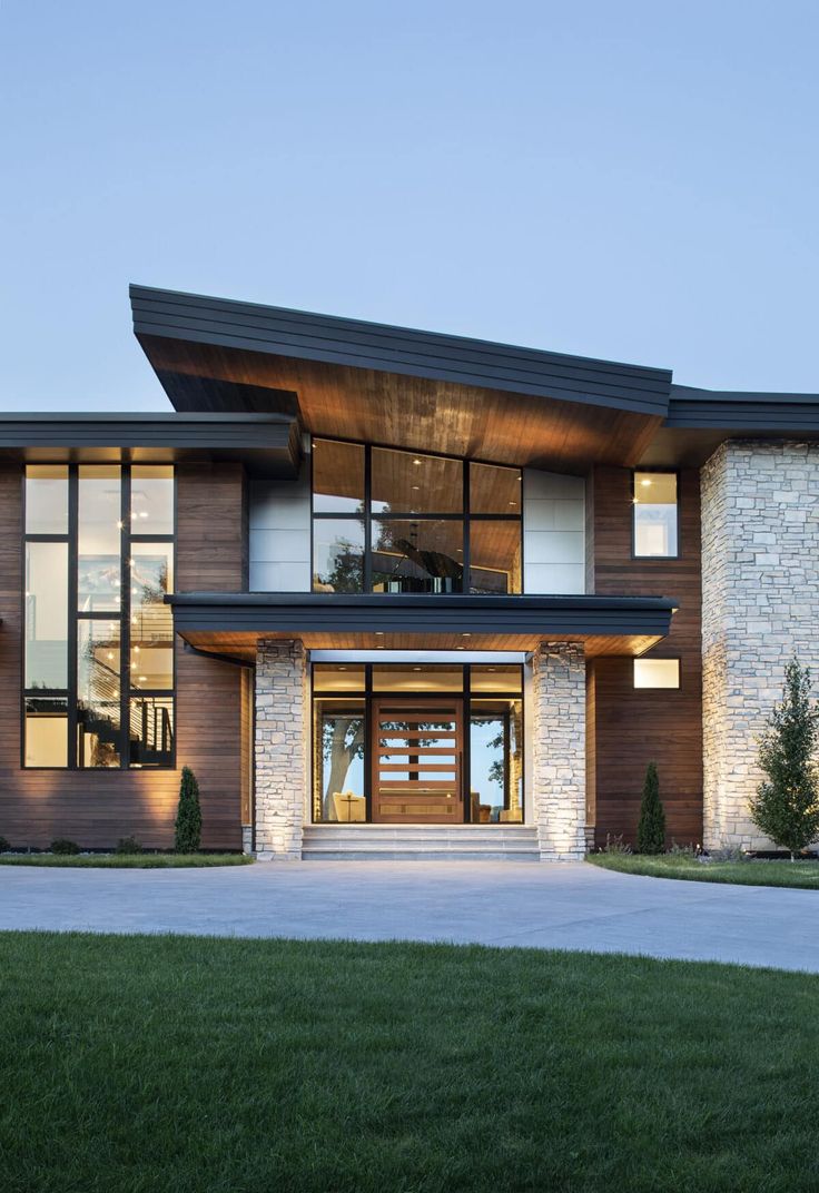 a large house with lots of windows and wood trimming on the side of it