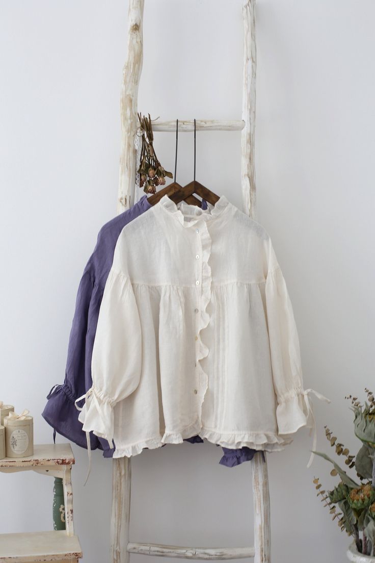 "This is a new-made linen blouse. Fully edged with lace. The sleeves is specially designed. Cuff tied with bow tie. Cute and romantic. Made of 100% nature linen. There are 2 colors available, white and bluish violet. Measures approximately (Loose type, suitable for all body types): 1/2 Bust: 80cm (31.5\") Length: 65cm (25.6\") Shoulder to Shoulder: 57cm (22.44\") ruffle Sleeve: 43cm (17\") There may be 1-2cm measurement margin. ---------------------------------------- Linen is a washable fabric, Ruffled Linen Blouse, Elegant Linen Blouse With Lace Trim, Spring Cottagecore Linen Blouse, Long Sleeve Linen Blouse With Ruffles, White Linen Blouse With Lace Trim, Elegant Long Sleeve Wedding Dresses, Violet Vintage, Stylish Short Dresses, Fashion Tops Blouse