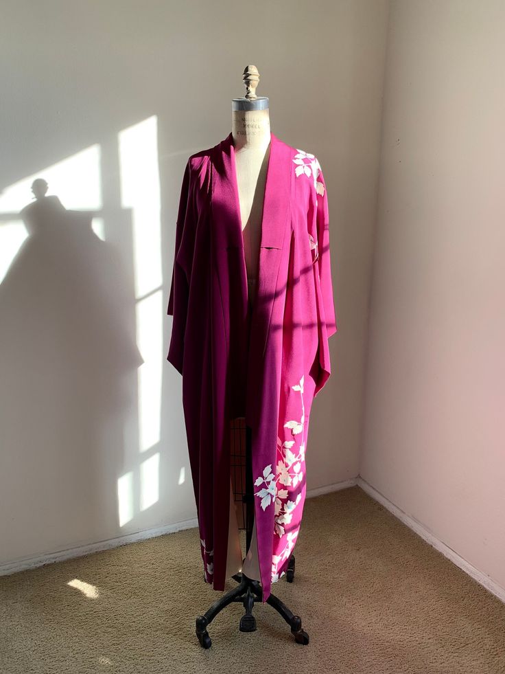 "Vintage 1950s purple silk kimono with a floral pattern.  Fits-like: One size fits most Length: 49\"  Good/Great *Some marks. Stains on the lining.  Dry clean only" Long Pink Silk Robe, Pink Silk Long Sleeve Kimono, Pink Silk Kimono For Spring, Pink Floral Print Open Front Kimono, Elegant Long Purple Kimono, Long Purple Kimono For Spring, Purple Floral Print Kimono For Spring, Spring Purple Floral Print Kimono, Purple Floral Print Kimono With Kimono Sleeves