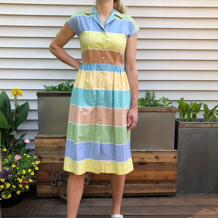 "Sweet cotton dress with white stripes of summer colors. Button front. In excellent condition. Note bottom button in photo has pulled- long stride. Measurements taken flat Bust 35\" Waist 26\" Hip. Open Back of neck to waist: 15 ½\" Length waist to hem: 27 ½\" Model is 5'10\" I can ship internationally. Please convo for pricing. PLEASE convo me if you have any further questions about this item or would like to see more pictures. I do my best to research items thoroughly before listing as well as Retro Summer Shirt Dress For Daywear, Striped Buttoned Shirt Dress For Summer, Cotton Short Sleeve Dresses With Vertical Stripes, Striped Shirt Dress With Buttons For The Beach, Striped Shirt Dress With Buttons For Summer, Casual Cotton Dress With Vertical Stripes, Cotton Dress With Vertical Stripes And Short Sleeves, Striped Summer Shirt Dress With Button Closure, Striped Shirt Dress With Button Closure For Summer