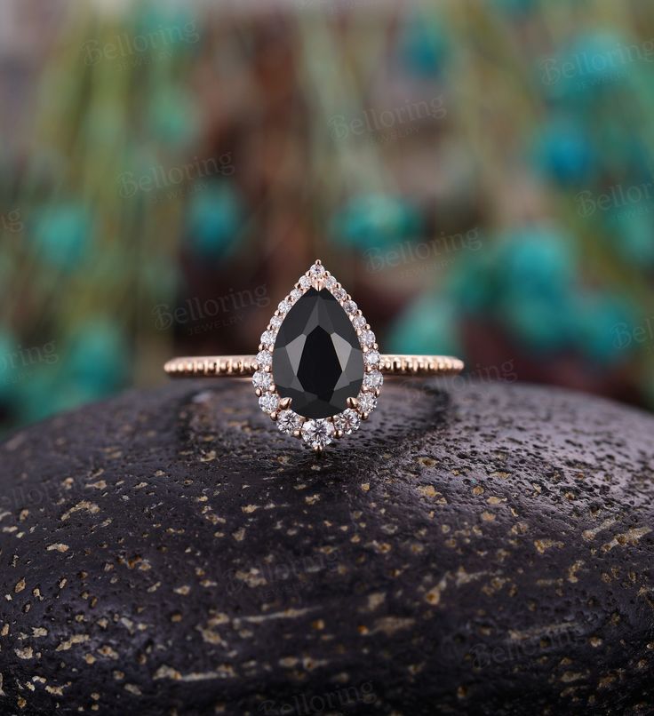 Pear shaped Black onyx engagement ring, Rose gold vintage milgrain moissanite/diamond halo ring, unique art deco anniversary wedding ring Alexandrite ring: https://www.etsy.com/listing/721949554 Moonstone ring: https://www.etsy.com/listing/877690804 Sandstone ring: https://www.etsy.com/listing/1052131188 Black rutilated quartz: https://www.etsy.com/listing/877688004 Back to Belloring shop: https://www.etsy.com/shop/BrilliantRing?ref=l2-shopheader-name ---------------------------Specifications--- Elegant Moissanite Promise Ring Jewelry, Elegant Moissanite Jewelry For Promise Ring, Elegant Halo Setting Promise Ring Jewelry, Black Onyx Engagement Ring Vintage, Elegant 14k Gold Jewelry With Halo Setting, Elegant Emerald Cut Halo Design Jewelry, Elegant Emerald Cut Halo Jewelry, Elegant Emerald Cut Jewelry With Halo Design, Elegant Jewelry With Emerald Cut Halo Design