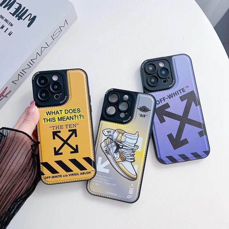 three phone cases with different designs on them, one is yellow and the other is purple