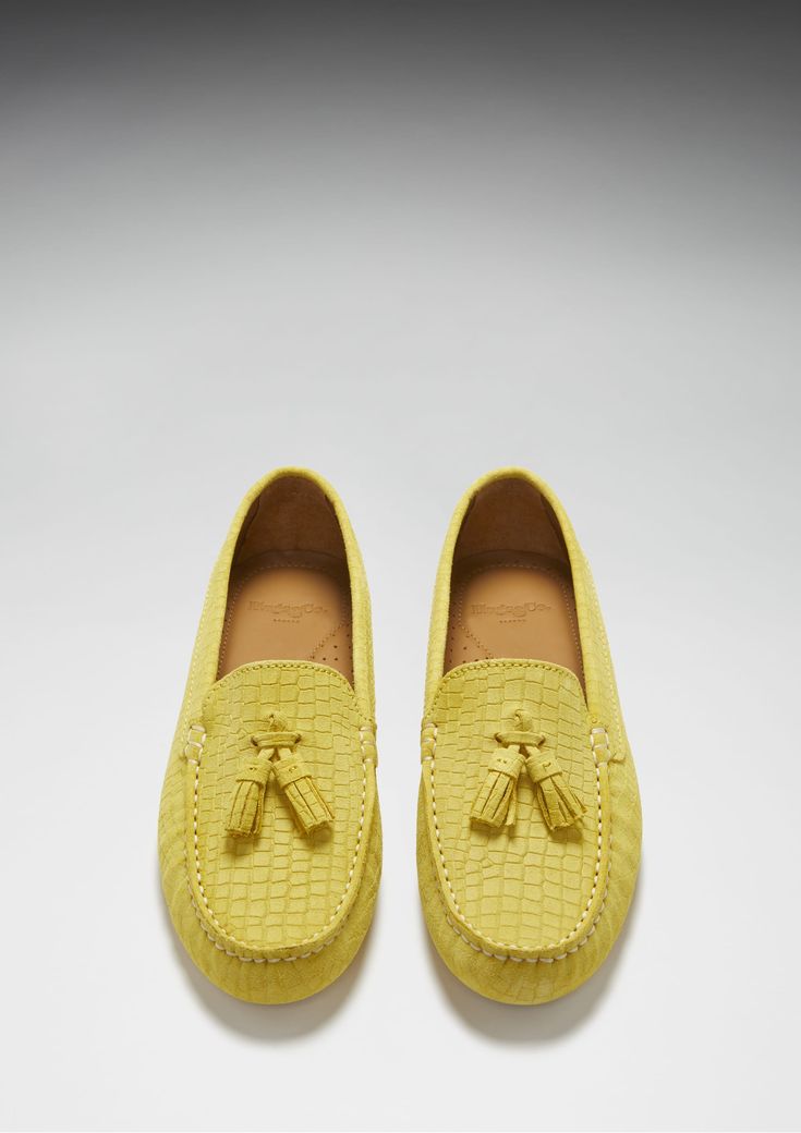 Hugs & Co. yellow tasselled loafer driving shoes for women. Moccasin style driving loafers in luxurious yellow suede upper embossed with a Gecko print pattern and lined with a soft leather for extra comfort. Made in Portugal 100% Suede Upper featuring a 100% Leather Lining Rubber studded sole Luxury Slip-on Tassel Loafers With Textured Sole, Yellow Leather Slip-on Loafers, Yellow Slip-on Moccasins With Rubber Sole, Yellow Formal Loafers For Spring, Formal Yellow Loafers For Spring, Yellow Round Toe Loafers For Formal Occasions, Yellow Slip-on Loafers For Formal Occasions, Yellow Suede Slip-on Loafers, Luxury Suede Loafers For Spring