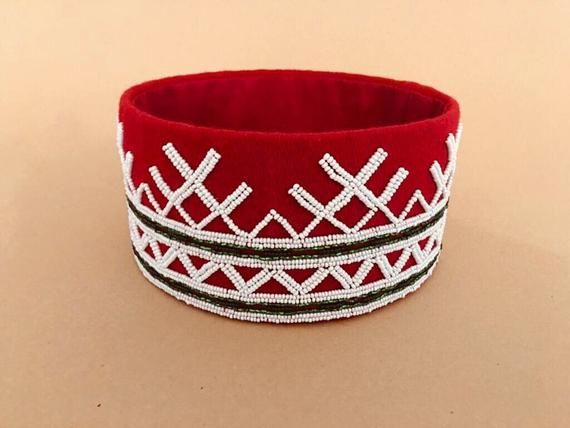 The crown is a handmade masterpiece made by an expert in Latvian folk clothing and traditions. People encounter each other in songs, dances, and writings. This unique crown is copy of a several hundred years old authentic crown worn by Latvians. The crown is a significant part of the Latvian folk clothing. The most popular is the base of a red color. IMPORTANT: Items can be custom-made to suit your personal needs or tailored to the correct size. Do not hesitate to contact our shop in case you ha Traditional Handmade Crown Headpiece, Handmade Traditional Crown Headpiece, Traditional Ceremonial Crown Headpieces, Traditional White Ceremonial Headpiece, Traditional Ceremonial Headpieces For Festivals, Traditional Handmade Headband, Traditional Handmade Headband For Festivals, Handmade Ceremonial Crown Headpiece, Traditional Adjustable Ceremonial Headpieces