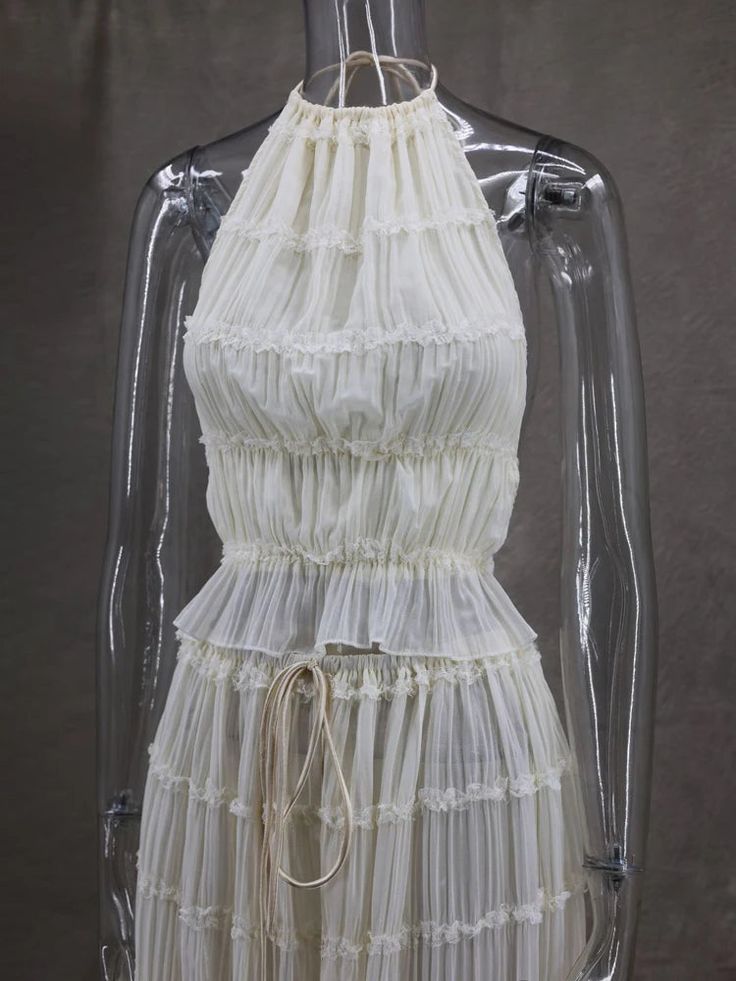 a white dress hanging on a mannequin