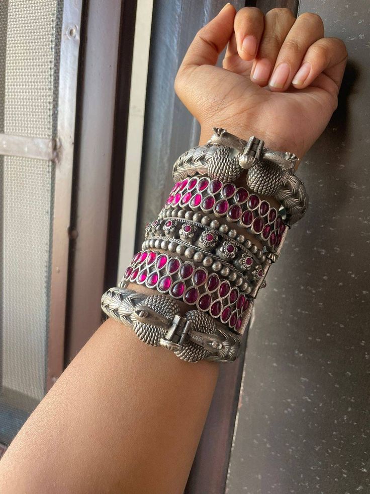 Silver bangles with peacock designs fashioned in oxidised silver, which are very traditional in nature. The bangle is versatile and adds just the right amount of pretty to your everyday ensembles. For a bolder appearance, layer and stack with another of the sorts. Openable bangle with 2.6 size, sometimes fits upto 2.8 Indian Jewelry Set, Stone Bangles, Bridal Jewellery Inspiration, Designers Jewelry Collection, American Diamond Jewellery, Boho Bangle, Fancy Jewellery Designs, The Bangles, Silver Jewellery Indian