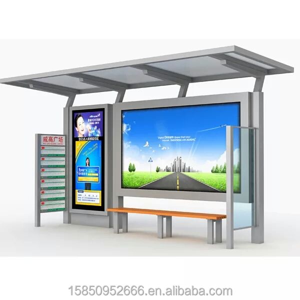 an outdoor kiosk with a bench in front of it and a large screen on the wall