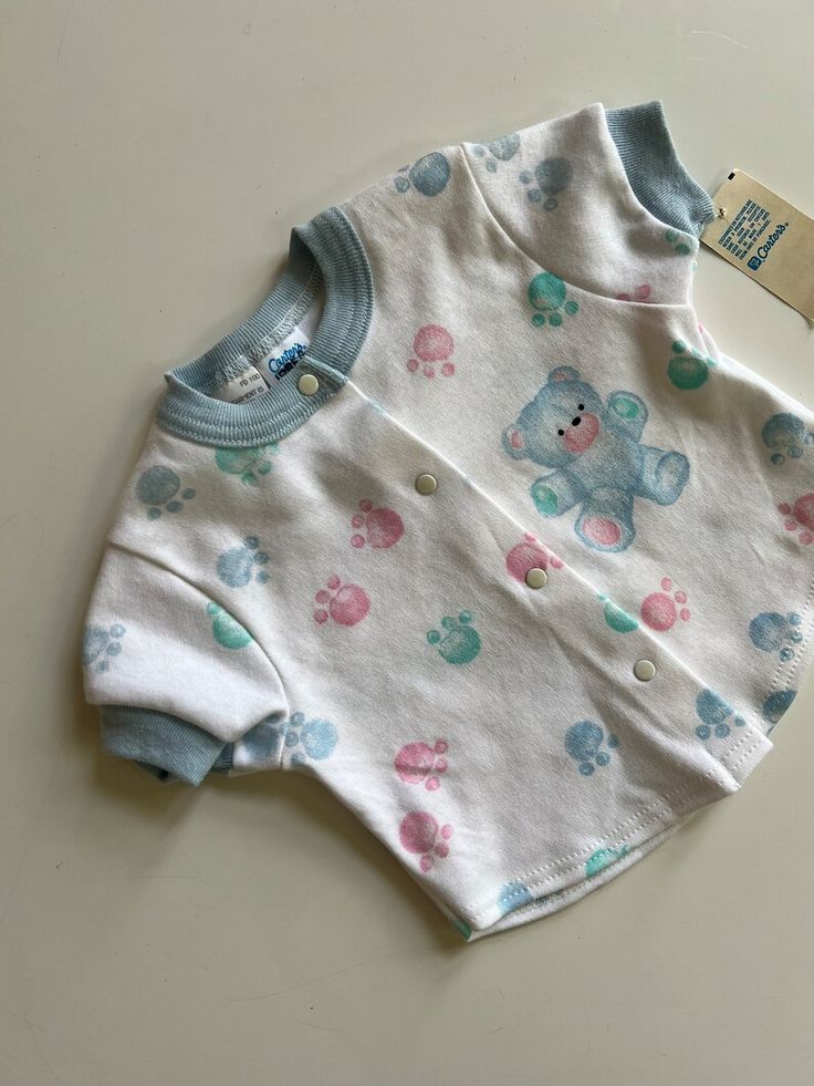 Vintage NWT Baby Vintage by Carter's Blue Bear with Pastel Paw Prints Snap Front Shirt Vintage with Tags for Baby #vintagebabyclothes #vintageNWTbabyclothes #vintagedeadstock #vintageCartersBaby #vintageunisexbaby #vintagegenderneutralbaby #vintagebabystyle Vintage Baby Style, Blue Bear, Vintage Baby Clothes, Carters Baby, Paw Prints, Gender Neutral Baby, Unisex Baby, Vintage Baby, Baby Tee