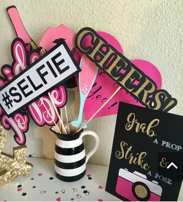 a table topped with lots of pink and black decorations