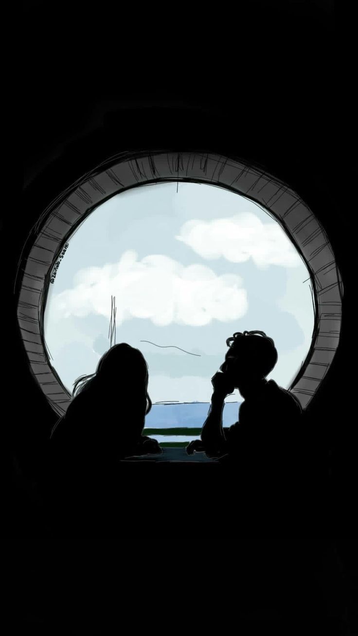 two people sitting in front of a round window