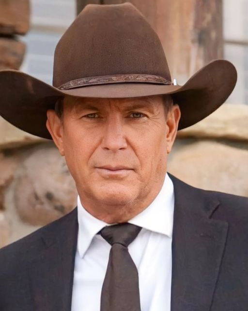 a man in a suit and tie wearing a cowboy hat with his face close to the camera