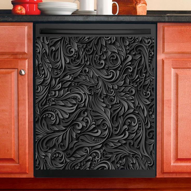 a black door mat sitting on top of a kitchen counter next to a bowl and cup