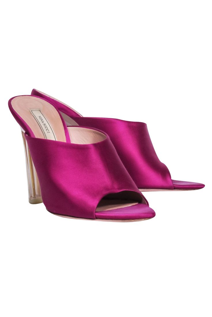 Step out in head-turning style with these Nina Ricci magenta pink satin mule pumps. The open toe heel showcases a clear heel design for a light and airy look, perfect for any date night. Make a statement and show off your fashion-savvy with these eye-catching and chic mules! Size 7.5 Satin fabric upper Clear acrylic heel Pointed toe Heel height 4" Luxury Pink Pointed Toe Mules, Pink Mules With 4-inch Heel And Open Heel, Pink Mules With 4-inch Open Heel, Luxury Satin Heels For Spring, Pink Mules With Sculpted Heel For Party, Pink Mules With 4-inch Heel For Party, Luxury Pink Mules For Evening, Pink Mules With Padded Open Heel, Elegant Pink Mules With Sculpted Heel