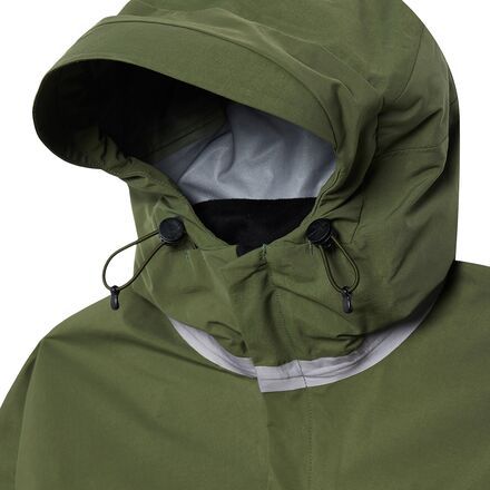 an image of a person wearing a green raincoat with hood up and zippers down